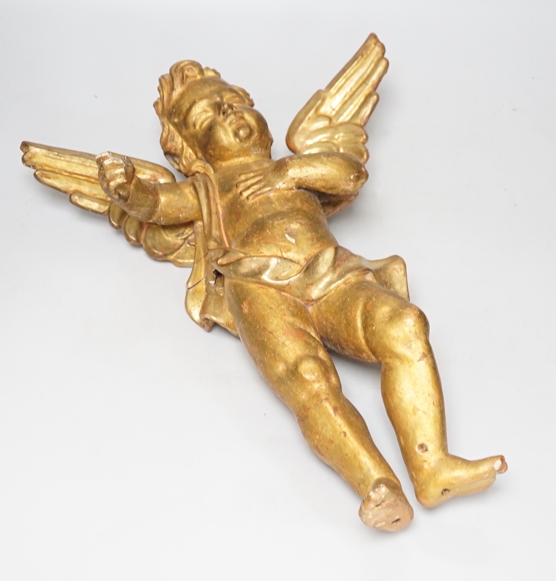 DO NOT RE-OFFER A Florentine carved gilt wood amorini, 39cm high